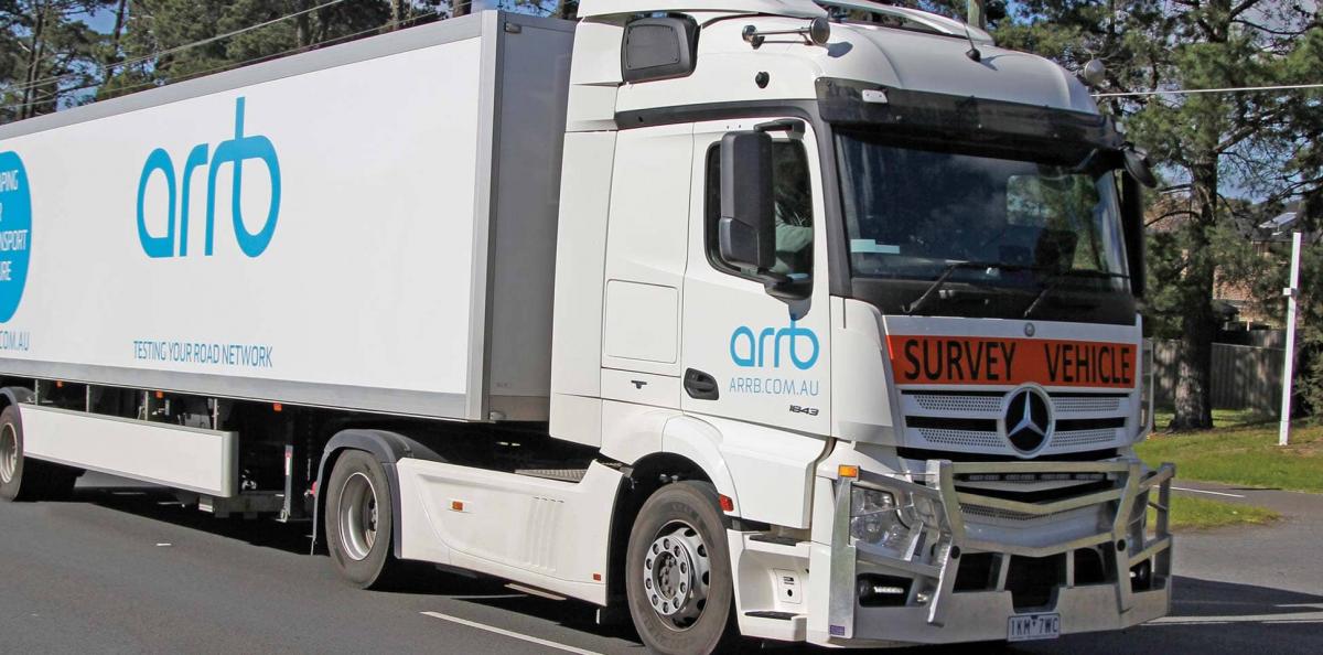 Side view of a truck with a survey vehicle sign