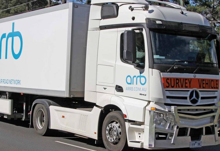 Side view of a truck with a survey vehicle sign