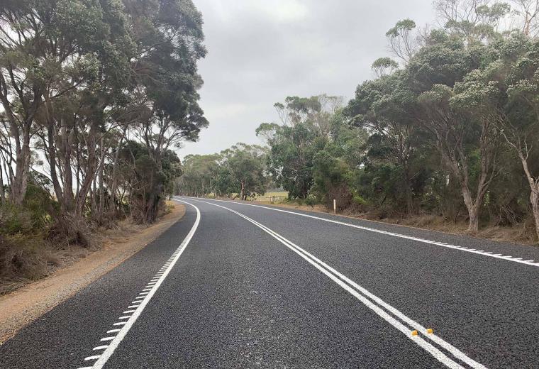 View of a country road from a drivers perspective.